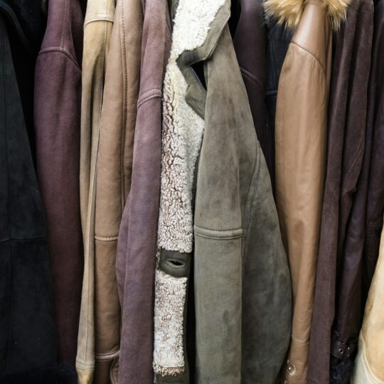 A collection of various leather jackets hanging