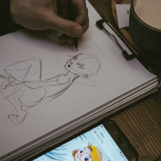 man drawing portrait of man