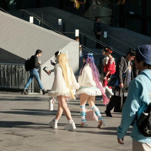A group of people walking down a street