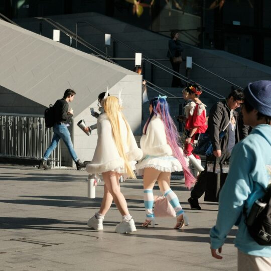 A group of people walking down a street