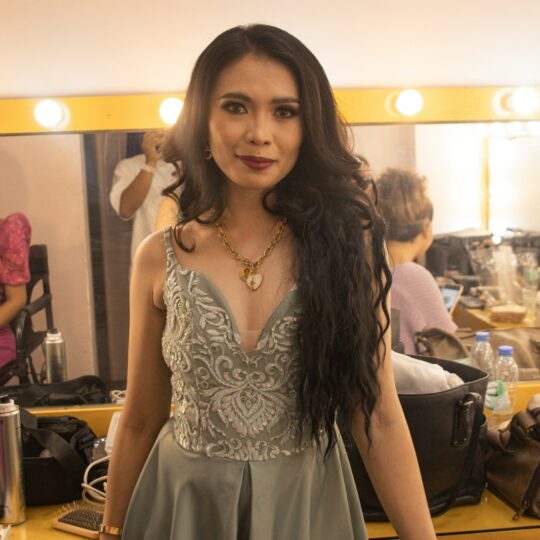 a woman standing in front of a mirror