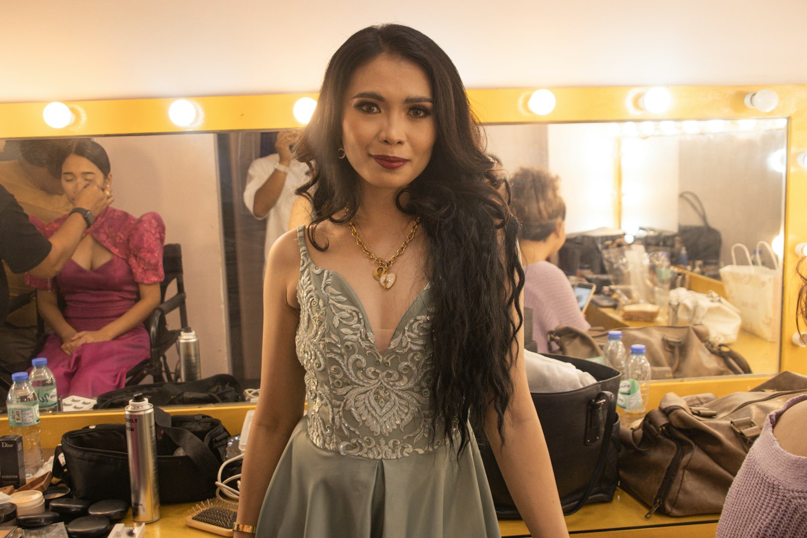 a woman standing in front of a mirror