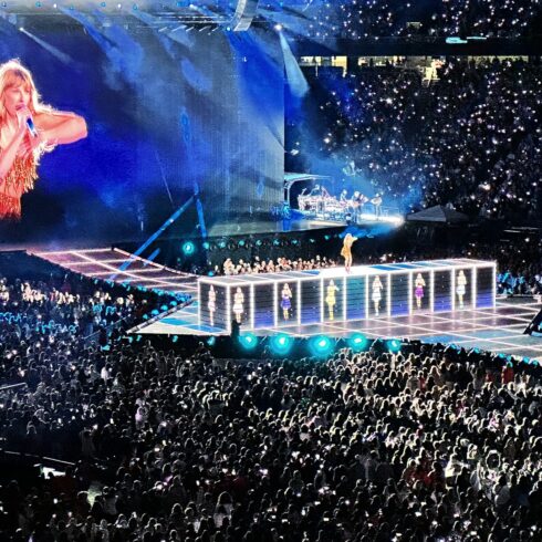 a crowd of people watching a woman on a stage